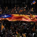 People holding Catalan pro-independence Estelada flags gather at Plaza Sant Jaume in Barcelona in 2022 to take part in a demonstration marking the fifth anniversary of a self-determination referendum organised by separatists despite being banned by the courts. Picture: AFP via Getty Images