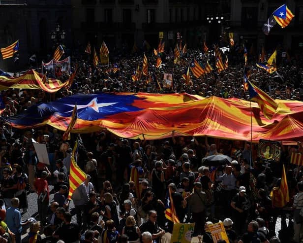 People holding Catalan pro-independence Estelada flags gather at Plaza Sant Jaume in Barcelona in 2022 to take part in a demonstration marking the fifth anniversary of a self-determination referendum organised by separatists despite being banned by the courts. Picture: AFP via Getty Images