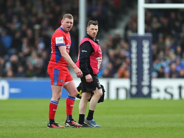 Finn Russell of Bath Rugby leaves the pitch following an injury against Exeter.