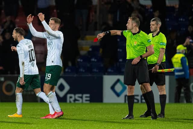 Hibs' Martin Boyle is shown a red card by referee Gavin Duncan.