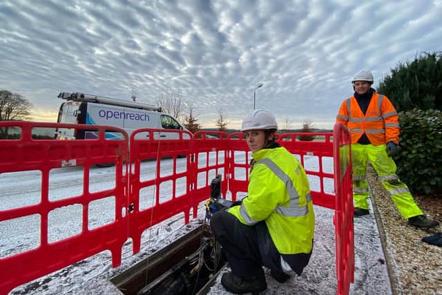 New recruits Lucy Kennedy (crouching) and Jodine Crombie (standing) at work on an Openreach fibre installation in Lanark.