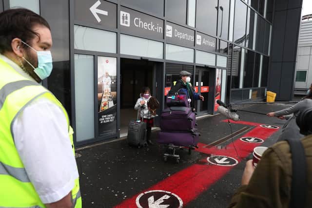 Chun Wong and his daughter Kiernan, 8, (permission given) leave Edinburgh airport after entering the country on the first day that travellers flying directly into Scotland on international flights have to self-isolate for 10 days in a quarantine hotel room.