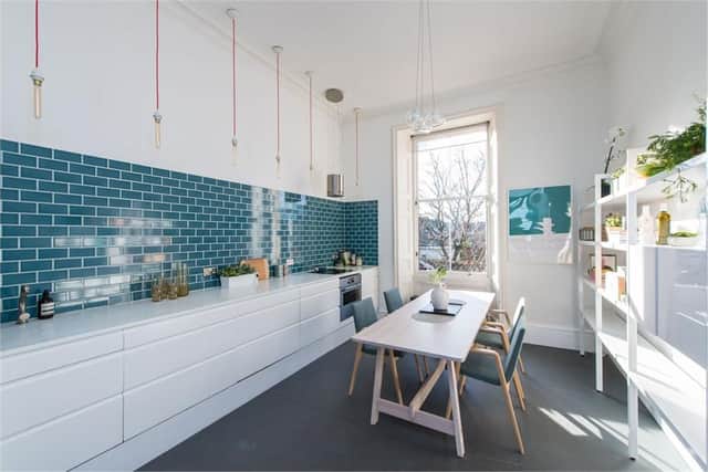 The modern kitchen has space for a dining table and chairs.
