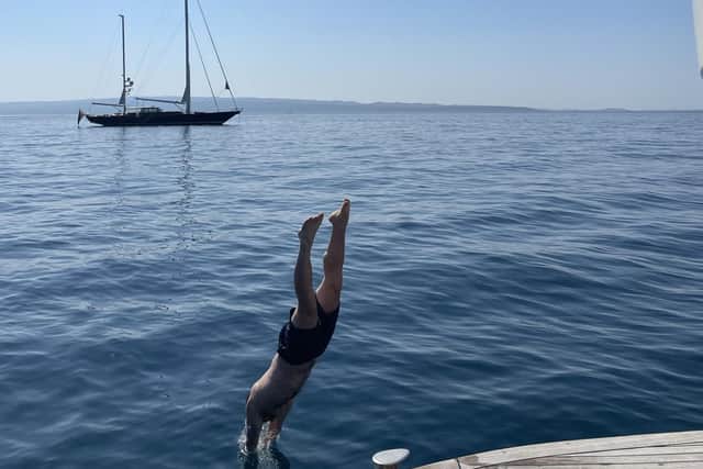 Diving from the Salve Di Mare into the Adriatic Sea on a Sail Croatia Explorer trip. Pic: Edd Draycott/PA.