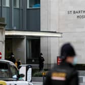 Police officers stand guard outside the St Bartholomew's Hospital where Prince Philip, Duke of Edinburgh is currently receiving treatment