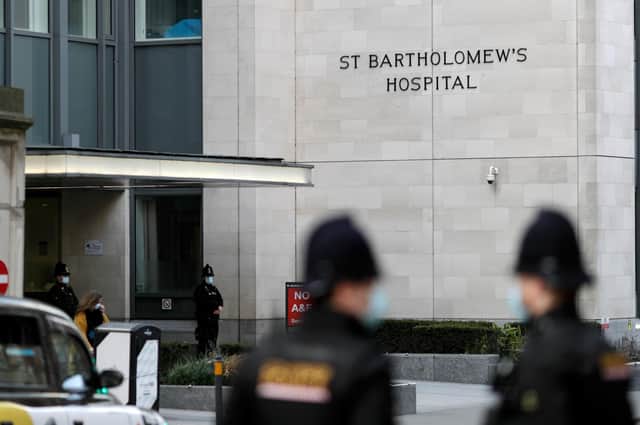 Police officers stand guard outside the St Bartholomew's Hospital where Prince Philip, Duke of Edinburgh is currently receiving treatment