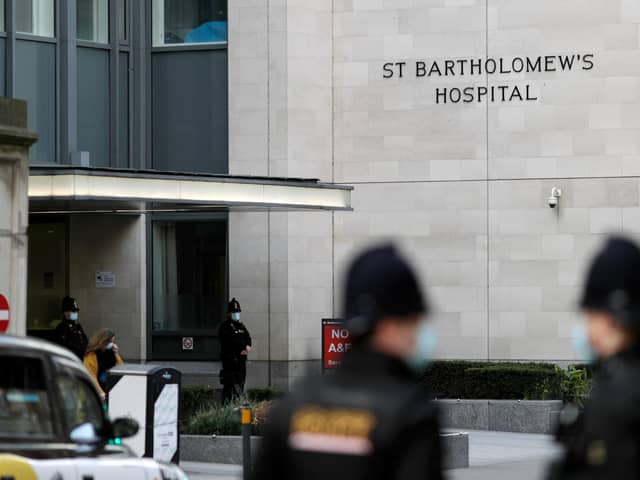 Police officers stand guard outside the St Bartholomew's Hospital where Prince Philip, Duke of Edinburgh is currently receiving treatment