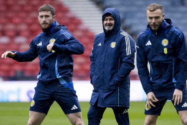 Scotland head coach Steve Clarke alongside Anthony Ralston and Ryan Porteous during a MD-1 session at Hampden.