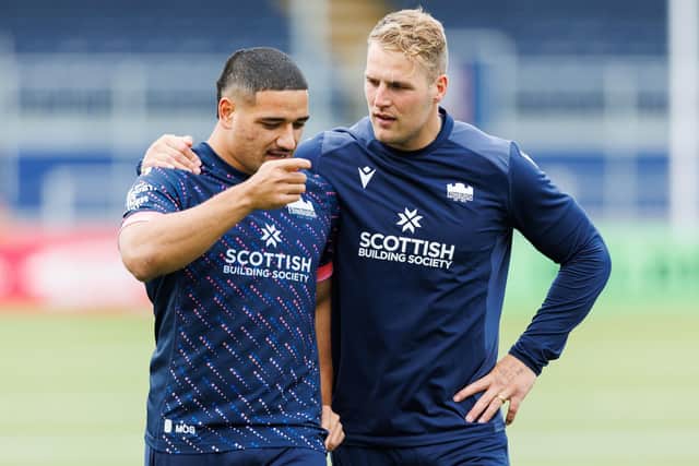 New Edinburgh centre Mosese Tuipulotu chats to Duhan van der Merwe during a training session at Hive Stadium. (Photo by Ross Parker / SNS Group)