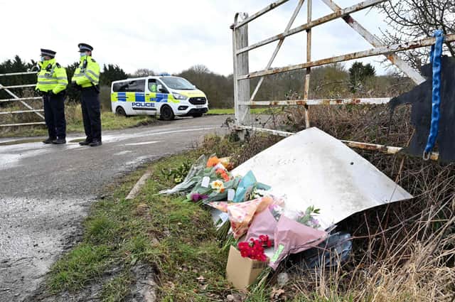 Flowers and messages of condolence for Sarah Everard left near the woodland where police officers found her remains near Ashford, southeast England (Picture: Glyn Kirk/AFP via Getty Images)