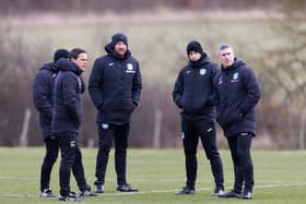 The Hibs coaching staff watch on ahead of Saturday's match against Ross County.