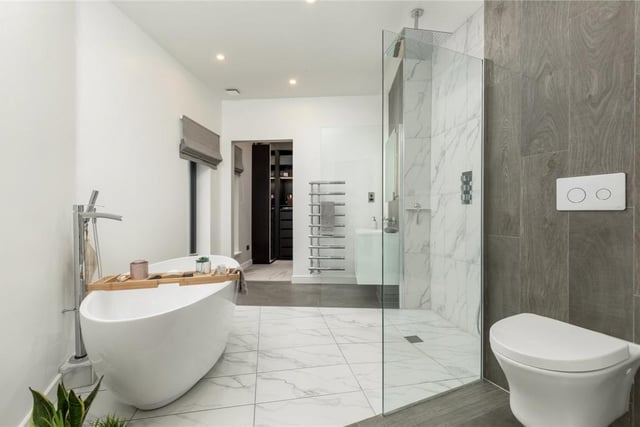 The beautiful principal bedroom en-suite with freestanding bath, walk-in shower, WC and wash hand basin.
