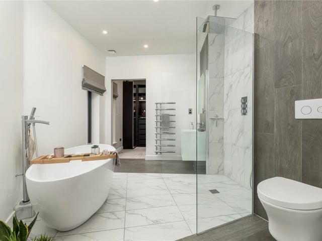 The beautiful principal bedroom en-suite with freestanding bath, walk-in shower, WC and wash hand basin.