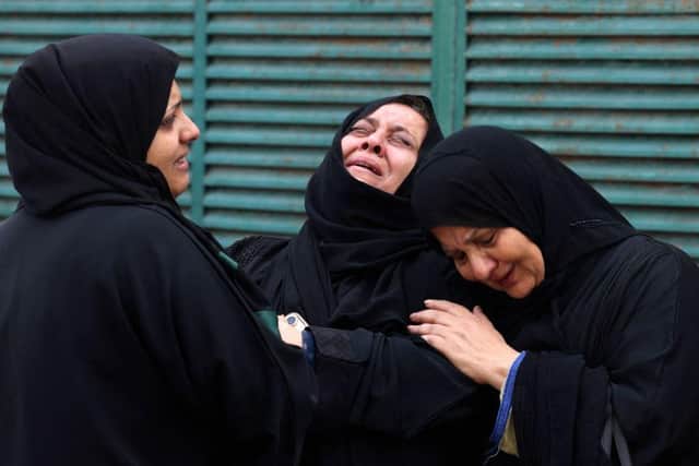Palestinians mourn during the funeral of a relative, killed in an Israeli strike in Gaza City.