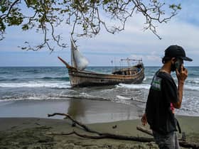 This picture shows a boat that was carrying Rohingya refugees after their arrival at a beach in Krueng Raya, Indonesia's Aceh province on December 25, 2022. (Photo by CHAIDEER MAHYUDDIN/AFP via Getty Images)