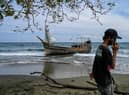 This picture shows a boat that was carrying Rohingya refugees after their arrival at a beach in Krueng Raya, Indonesia's Aceh province on December 25, 2022. (Photo by CHAIDEER MAHYUDDIN/AFP via Getty Images)