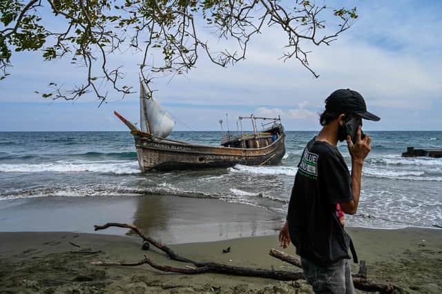 This picture shows a boat that was carrying Rohingya refugees after their arrival at a beach in Krueng Raya, Indonesia's Aceh province on December 25, 2022. (Photo by CHAIDEER MAHYUDDIN/AFP via Getty Images)