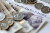 Money stacked on top of a council tax bill. PIC: Danny Lawson/PA Wire
