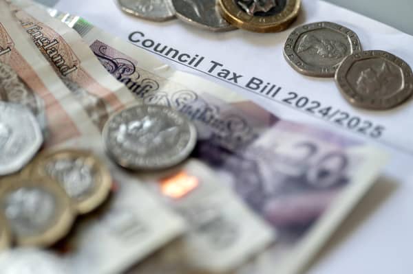 Money stacked on top of a council tax bill. PIC: Danny Lawson/PA Wire