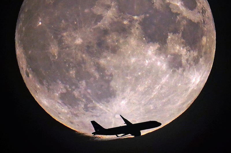 A plane passes the super blue moon in London. Picture: Victoria Jones/PA Wire