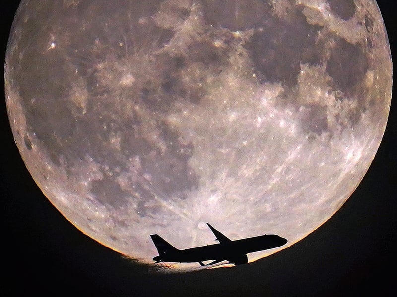 A plane passes the super blue moon in London. Picture: Victoria Jones/PA Wire