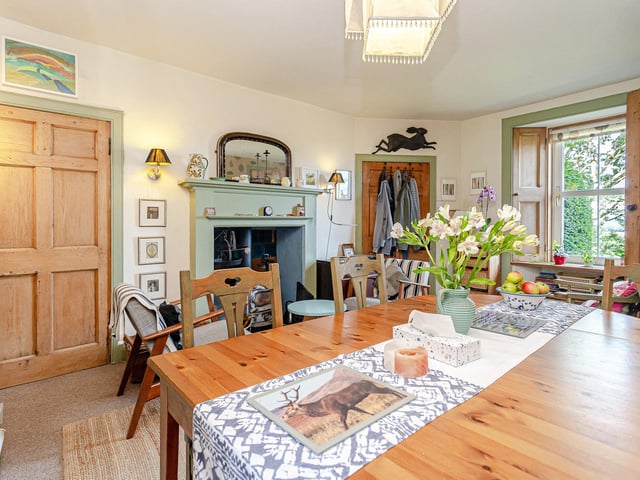 Interior: The accommodation includes a welcoming reception hall, a lounge with open fire and window shutters, kitchen, formal dining room, and a conservatory with access to the property’s enclosed garden. Two large bedrooms occupy the first floor.