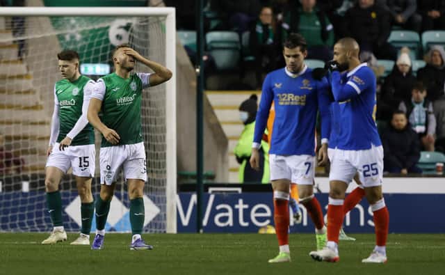 Hibs' Ryan Porteous is left dejected after his foul leads to a penalty against Rangers.