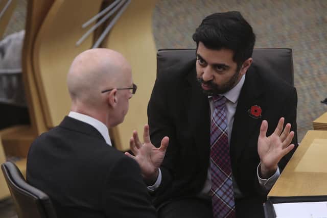 Deputy First Minister John Swinney consults health secretary, Humza Yousaf during First Minster's Questions at the Scottish Parliament in Holyrood. Picture: PA