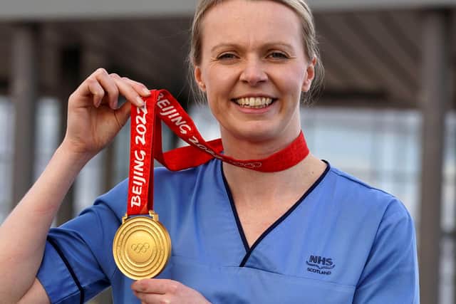 Vicky Wright shows off her Olympic curling gold medal as she starts a nursing shift at Forth Valley Hospital.