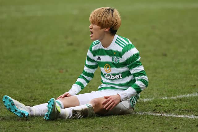Celtic's Kyogo Furuhashi suffers an injury against St. Johnstone on Boxing Day. (Photo by Craig Williamson / SNS Group)