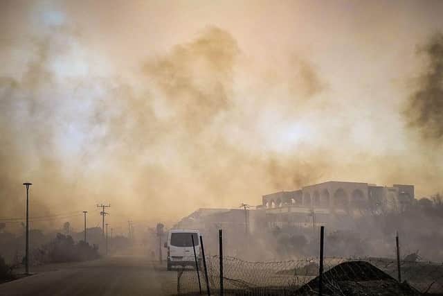 This photograph from Saturday shows smoke rising from a burnt hotel complex during a wildfire on the Greek island of Rhodes.