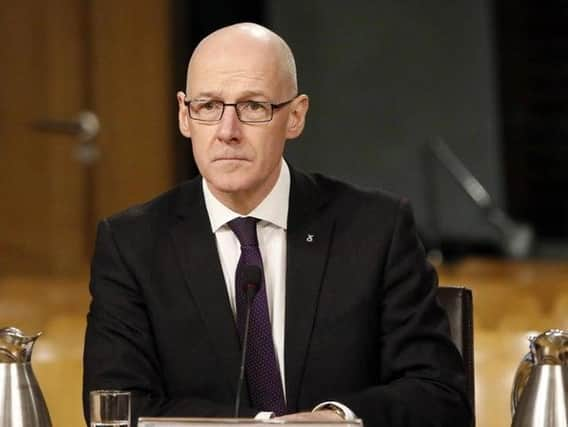 John Swinney defended the moderation system