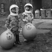 Little boys show off their Xmas presents (including astronaut suits and Space Hoppers) in Crown Street in the Gorbals area of Glasgow in December 1970.