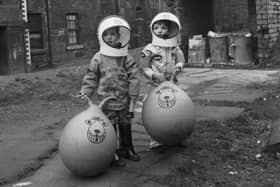 Little boys show off their Xmas presents (including astronaut suits and Space Hoppers) in Crown Street in the Gorbals area of Glasgow in December 1970.