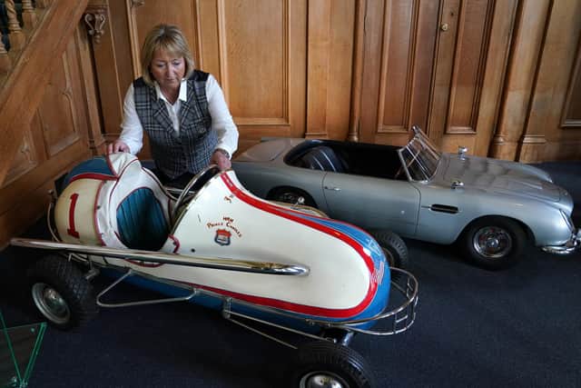 Assistant Curator Sarah Hoare views toy cars used by young royals. Pic: Andrew Milligan