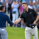 Ludvig Aberg shakes hands with Rory McIlroy on the 18th green at the end of their opening round in the BMW PGA Championship at Wentworth Club. Picture: Ross Kinnaird/Getty Images.
