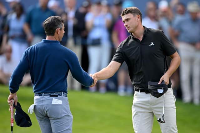Ludvig Aberg shakes hands with Rory McIlroy on the 18th green at the end of their opening round in the BMW PGA Championship at Wentworth Club. Picture: Ross Kinnaird/Getty Images.