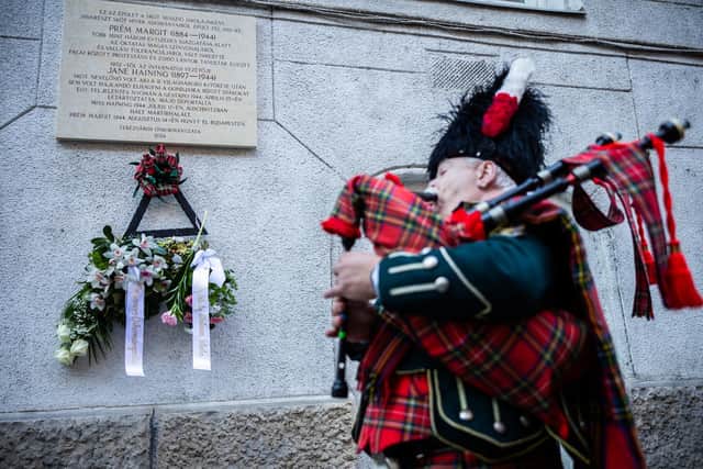 A piper plays during the unveiling of the Jane Haining memorials outside St Columba's Church of Scotland in Budapest. Photo: Barta Bálint/Church of Scotland/PA Wire