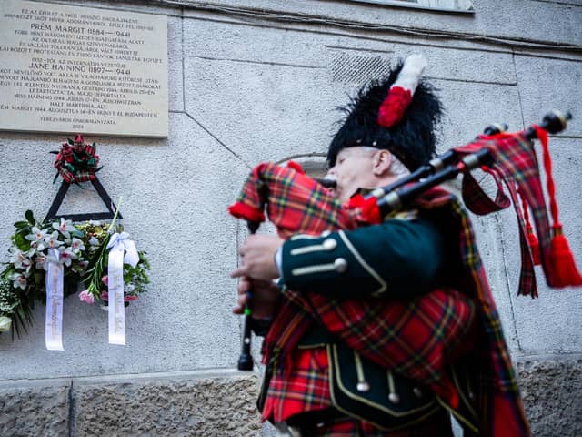 A piper plays during the unveiling of the Jane Haining memorials outside St Columba's Church of Scotland in Budapest. Photo: Barta Bálint/Church of Scotland/PA Wire