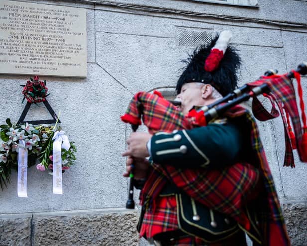 A piper plays during the unveiling of the Jane Haining memorials outside St Columba's Church of Scotland in Budapest. Photo: Barta Bálint/Church of Scotland/PA Wire