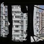 A broken window of a heavily damaged flat can be seen in the high-rise residential building hit by remains of a shot down Russian drone in Kyiv. Picture: Genya Savilov/AFP via Getty Images