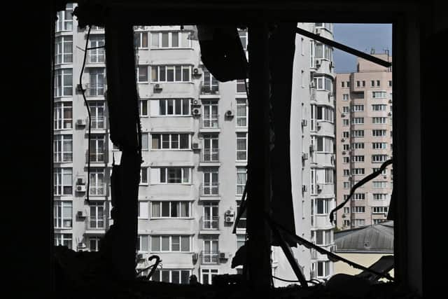 A broken window of a heavily damaged flat can be seen in the high-rise residential building hit by remains of a shot down Russian drone in Kyiv. Picture: Genya Savilov/AFP via Getty Images