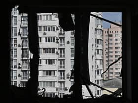 A broken window of a heavily damaged flat can be seen in the high-rise residential building hit by remains of a shot down Russian drone in Kyiv. Picture: Genya Savilov/AFP via Getty Images