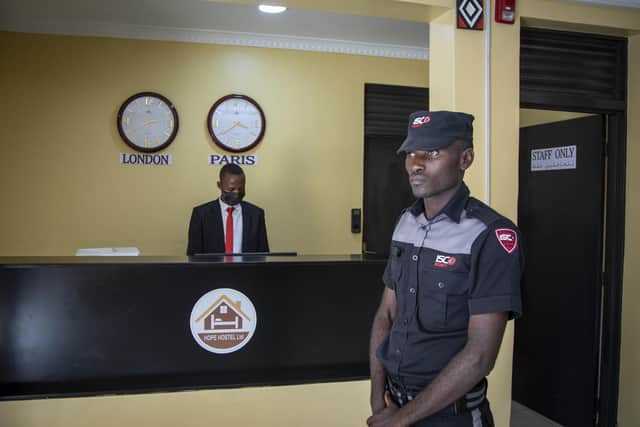 A security guard stands in the reception area of the Hope Hostel, which is one of the locations expected to house some of the asylum-seekers due to be sent from Britain to Rwanda. Photo: AP Photo.