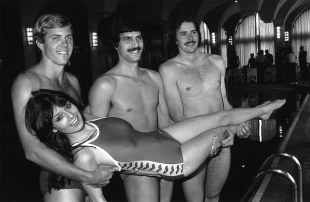 David Wilkie and fellow swimmers Gary Hall and Mark Spitz prepare to throw actress Laraine Humphrys into the pool. Picture: Graham Morris/Evening Standard/Getty Images