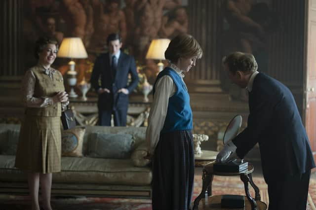 This image released by Netflix shows Olivia Colman, from left, Josh O'Connor and Emma Corrin in a scene from "The Crown." Season four premieres on Sunday, Nov. 15. (Des Willie/Netflix via AP)