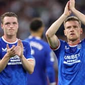 Rangers duo Leon King and Steven Davis applaud their supporters after their 4-0 defeat to Ajax in Amsterdam. (Photo by KENZO TRIBOUILLARD/AFP via Getty Images)