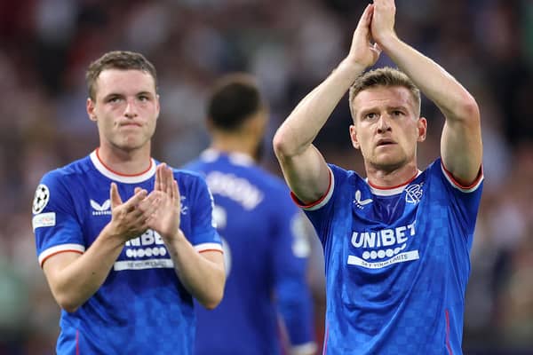 Rangers duo Leon King and Steven Davis applaud their supporters after their 4-0 defeat to Ajax in Amsterdam. (Photo by KENZO TRIBOUILLARD/AFP via Getty Images)