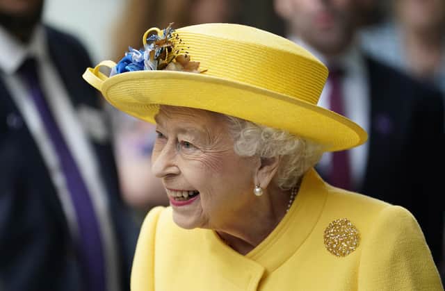 Queen Elizabeth II dressed in yellow at Paddington station in London, to mark the completion of London's Crossrail project.