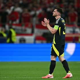 A dejected Andrew Robertson applauds at Scotland fans after the 1-0 defeat to Hungary that knocked his side out of Euro 2024. (Photo by FABRICE COFFRINI/AFP via Getty Images)